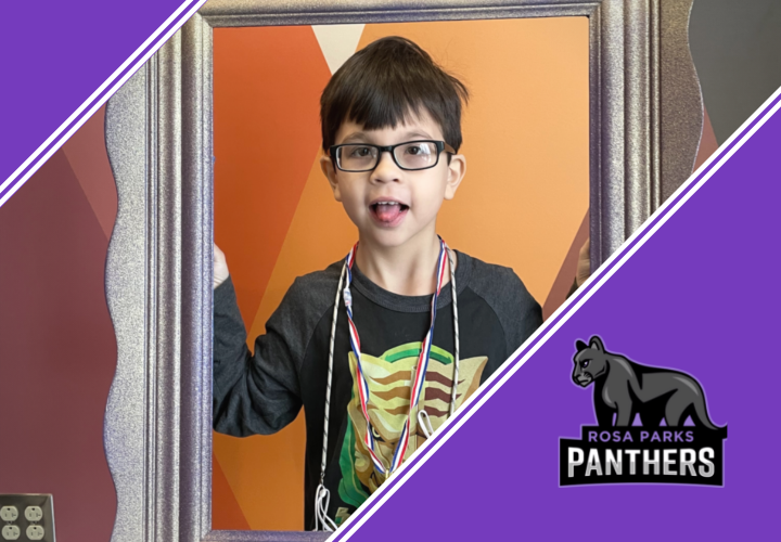 Young boy holding picture frame